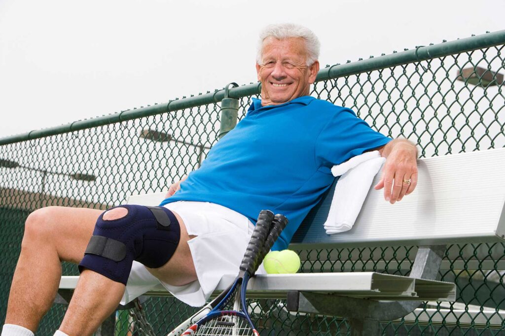 Active senior wearing a knee brace